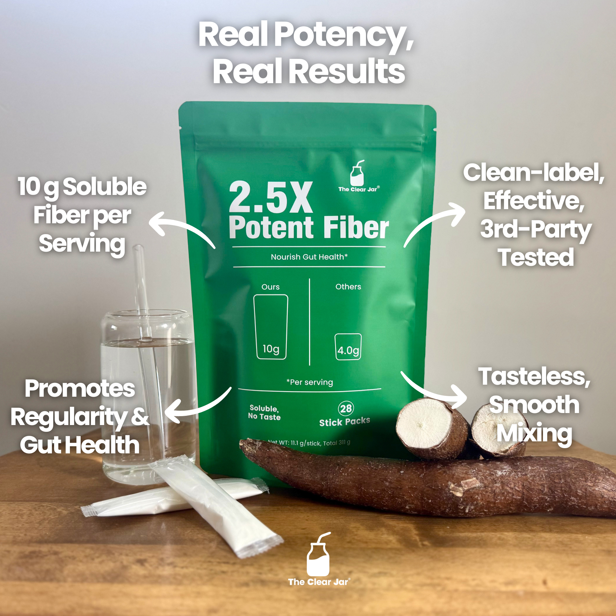 Green fiber supplement package with glass of water, fiber stick, and root on a wooden surface.